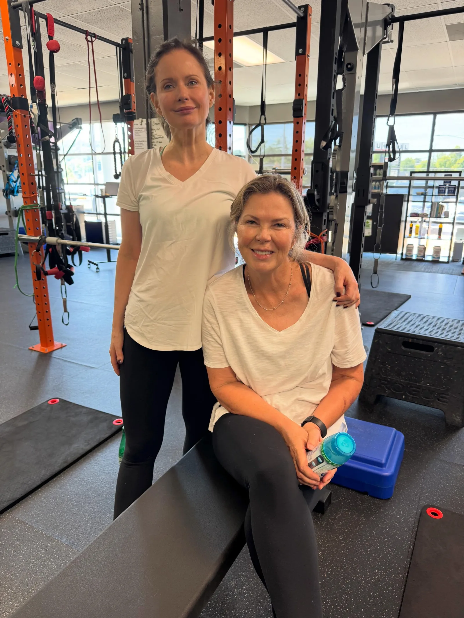 Two smiling members together after a training session